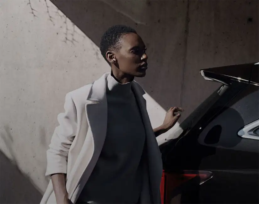 Lady in coat holding Kia