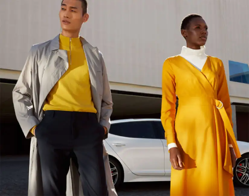 Lady and man standing in front of Kia