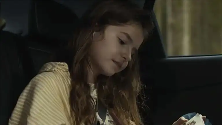 Hero image of girl in Kia vehicle
