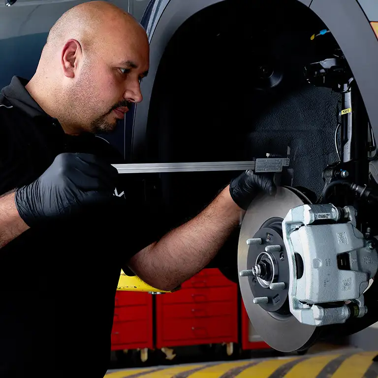 Technician checking brakes