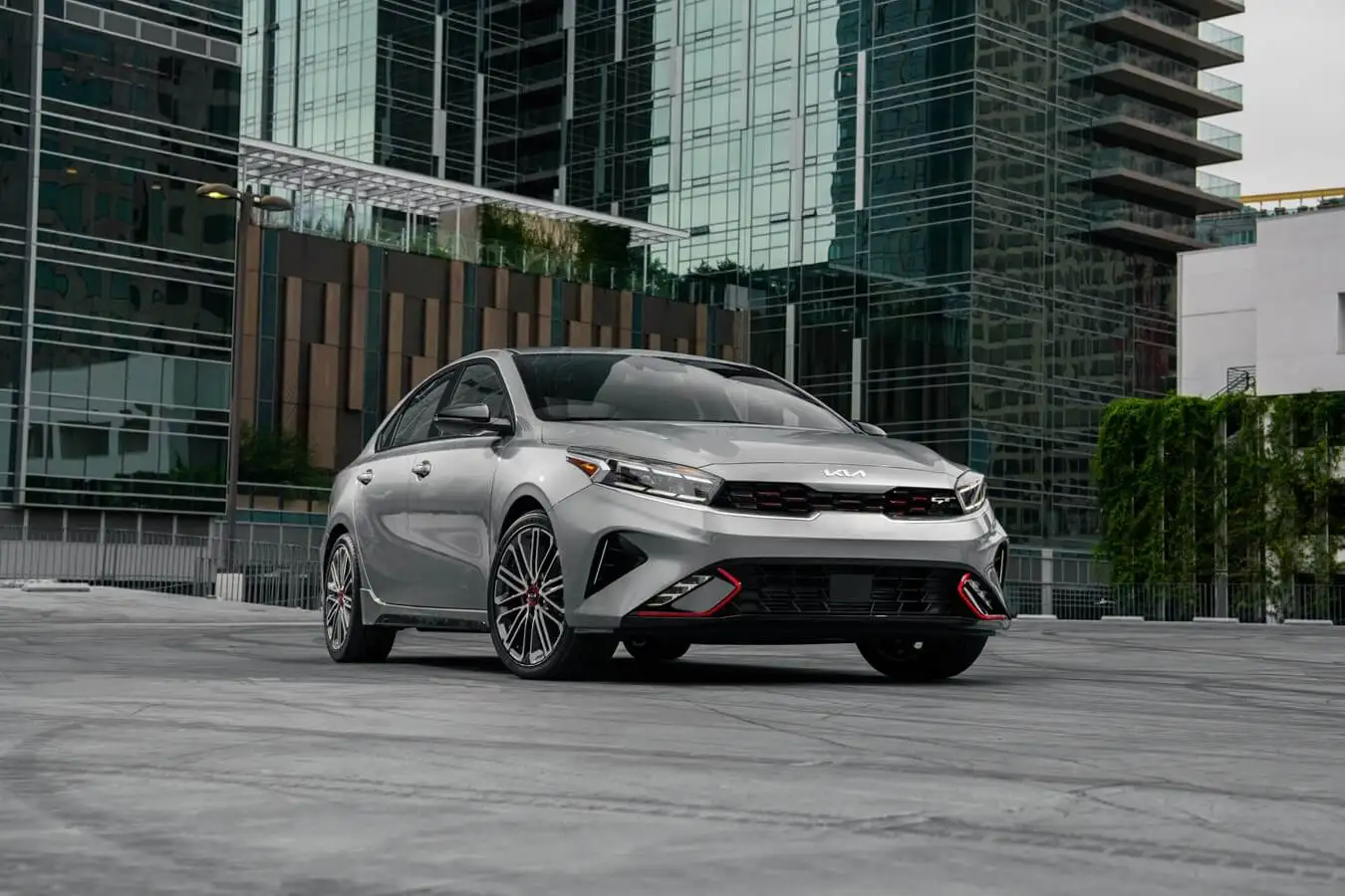 2023 Kia Forte in front of glass high-rise buildings in the middle of Toronto.