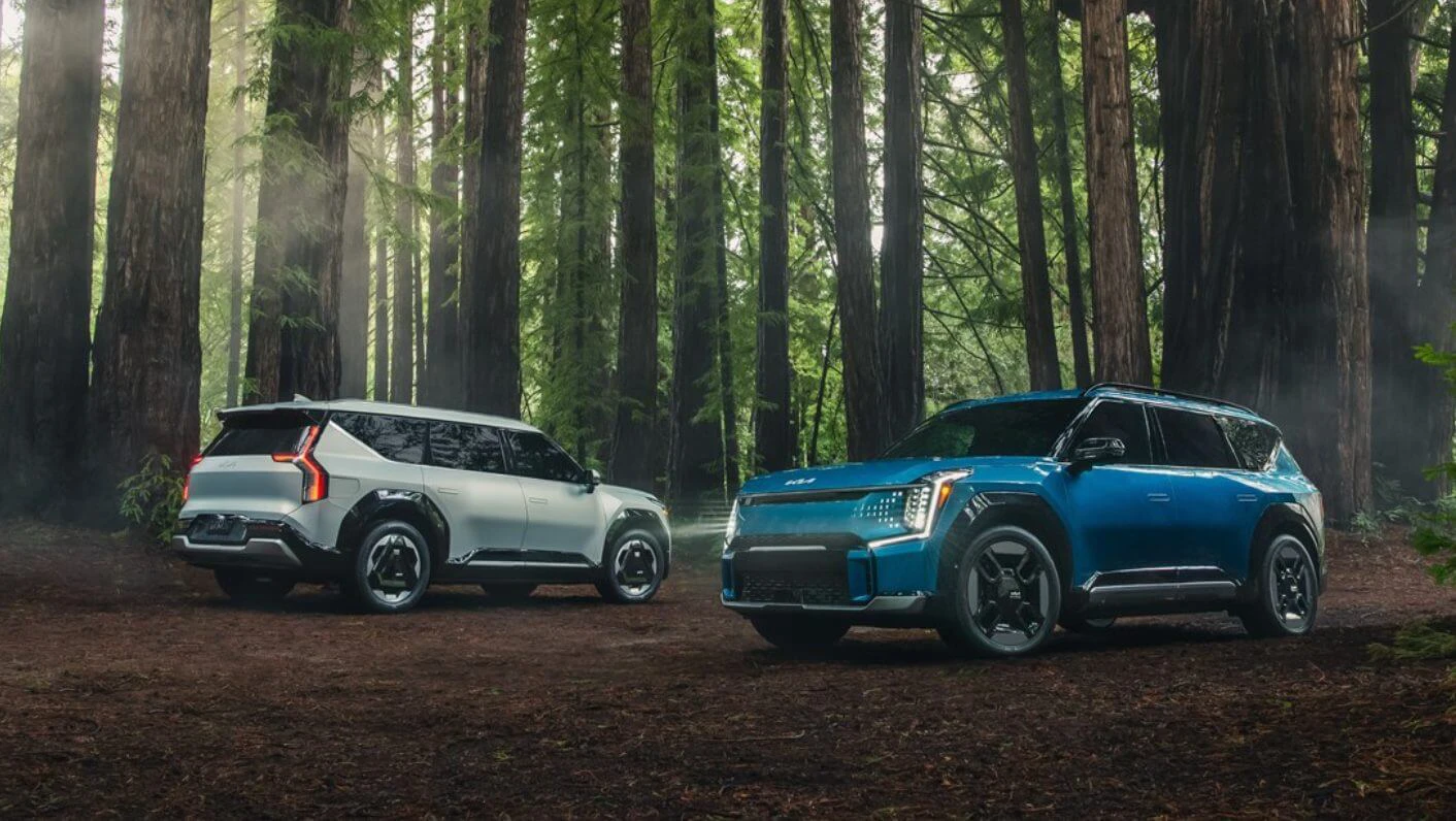 Two EV9s Parked Side By Side In Forest