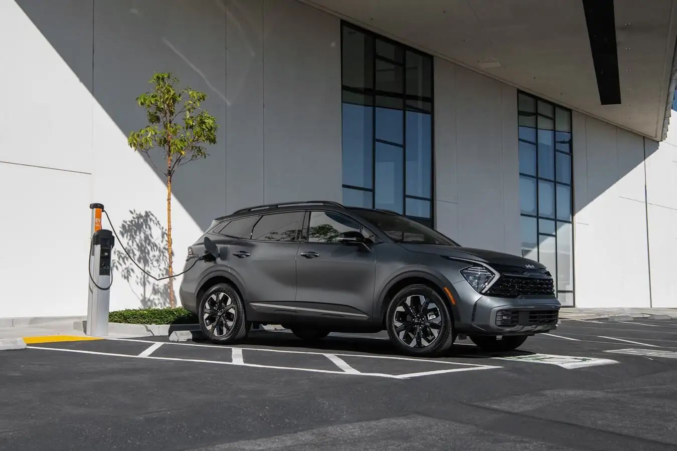 2023 Kia Sportage back hatch/trunk area. One half of image with seats up and other half with seats down showing full capacity.