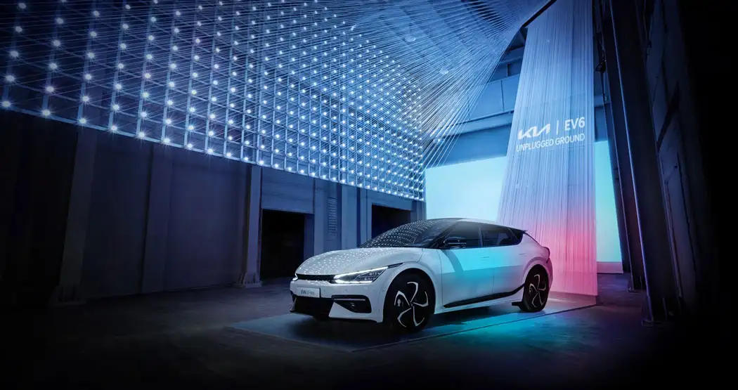 Kia EV6 in white with neon background