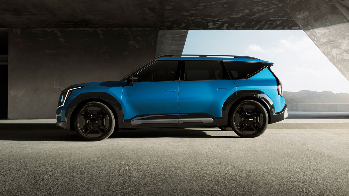Official Kia Canada image of a blue Kia EV9 electric three-row SUV in side profile