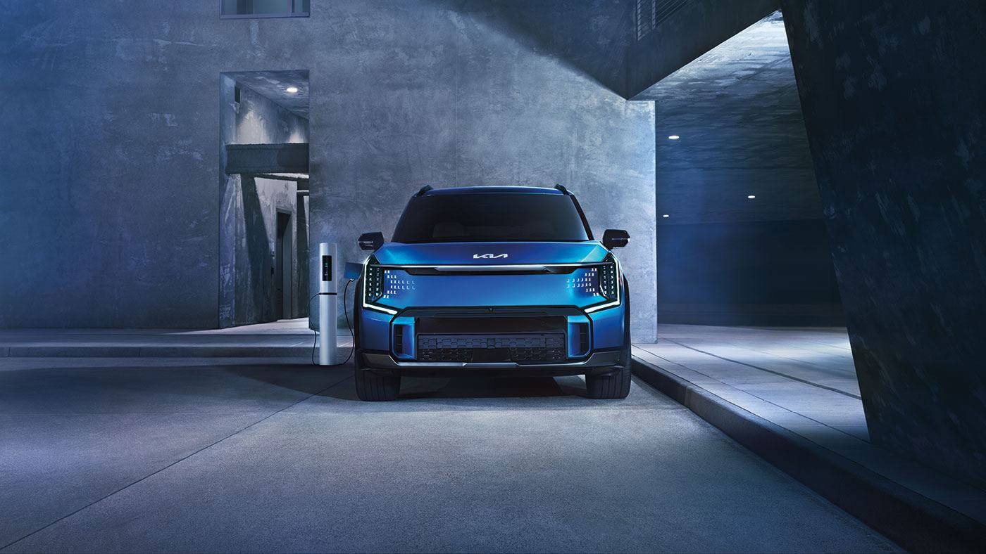 Kia EV9 Land AWD with GT-Line in Ocean Blue charging battery.