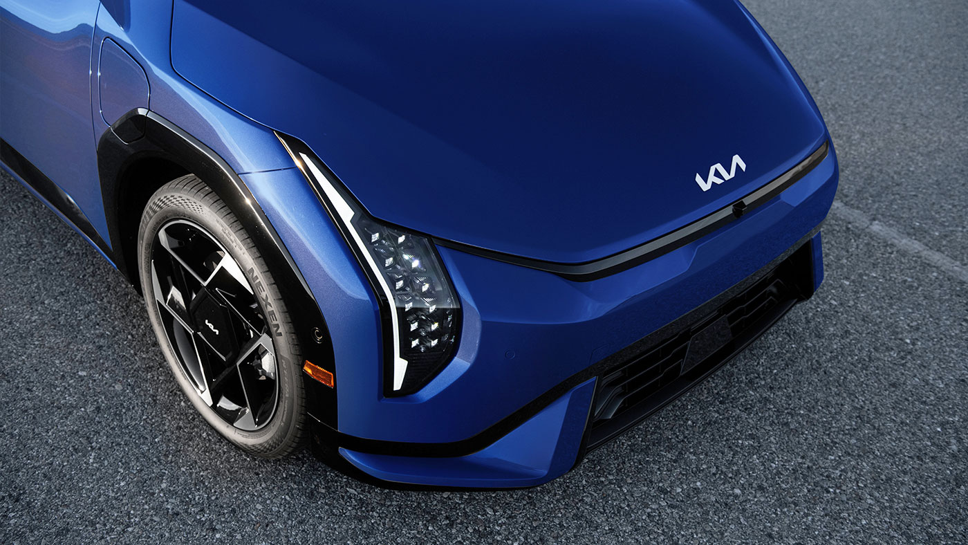Blue Kia EV4 electric sedan front exterior LED headlights