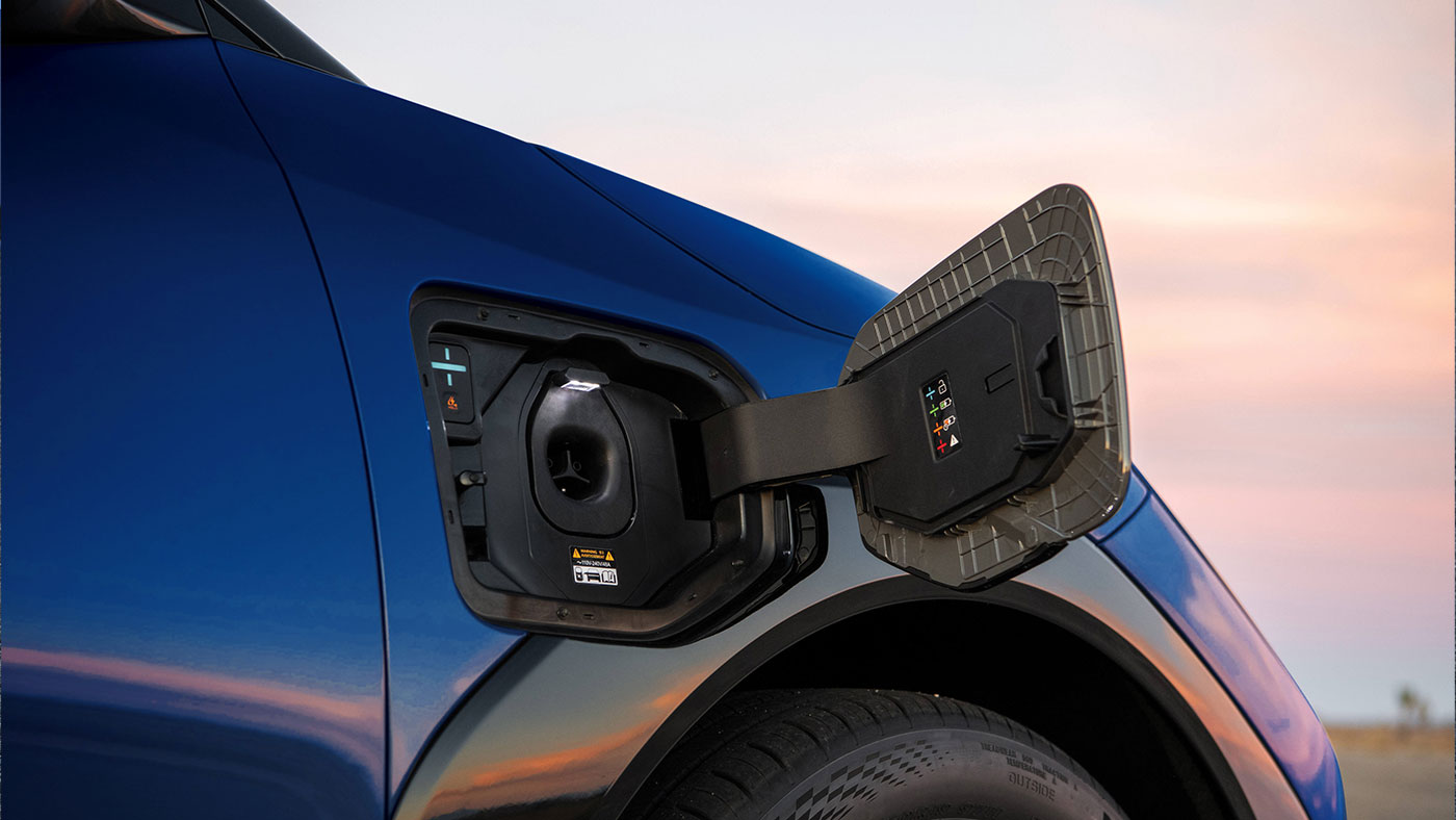 Blue Kia EV4 electric sedan NACS charging port