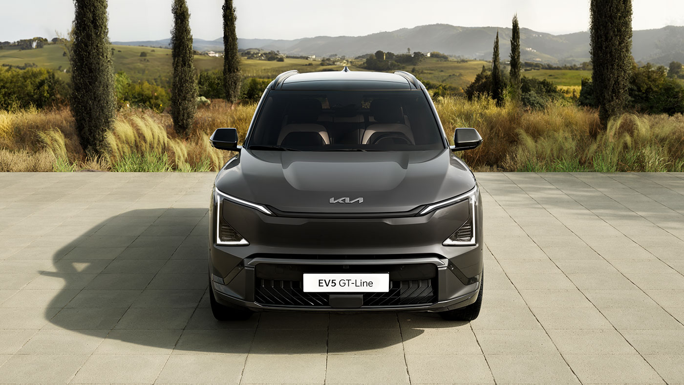 Grey Kia EV5 electric Compact SUV on road front exterior