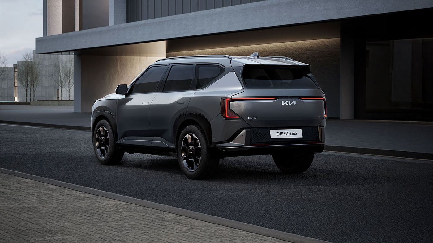 Grey Kia EV5 electric Compact SUV on road rear exterior