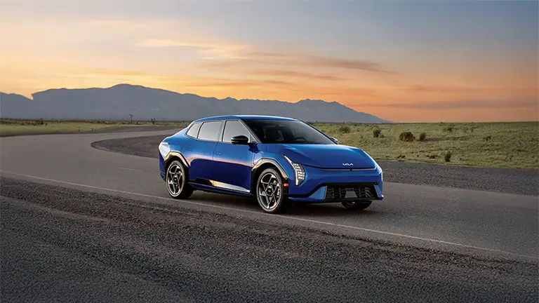 2026 electric sedan Kia EV4 in Yatch Blue exterior on road