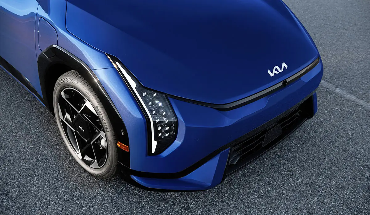 Blue Kia EV4 electric sedan front exterior LED headlights