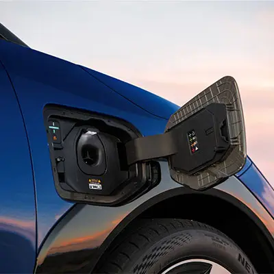 Blue Kia EV4 electric sedan NACS charging port