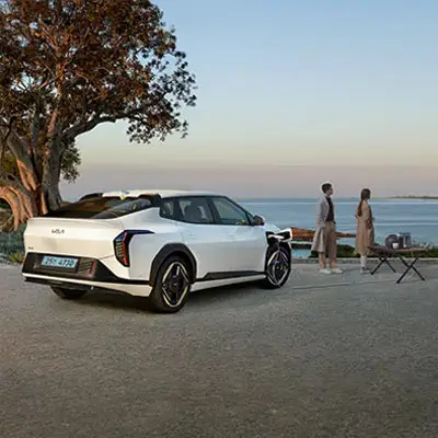 White Kia EV4 electric sedan tech feature Vehicle-to-Load (V2L)