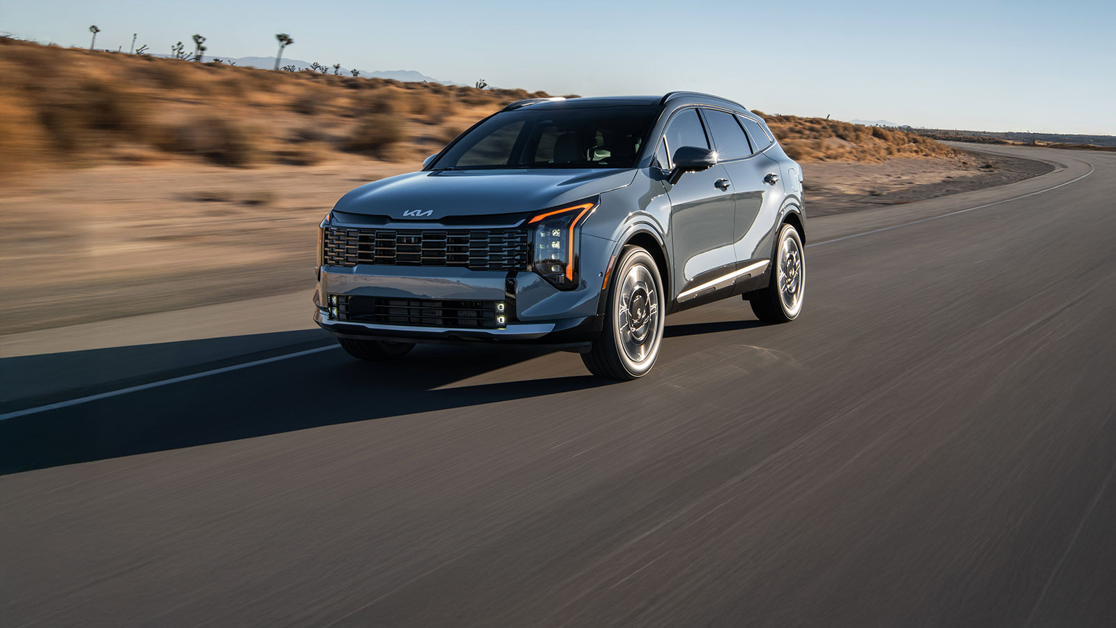 Official Kia Canada image of a blue 2026 Sportage Hybrid driving on a road