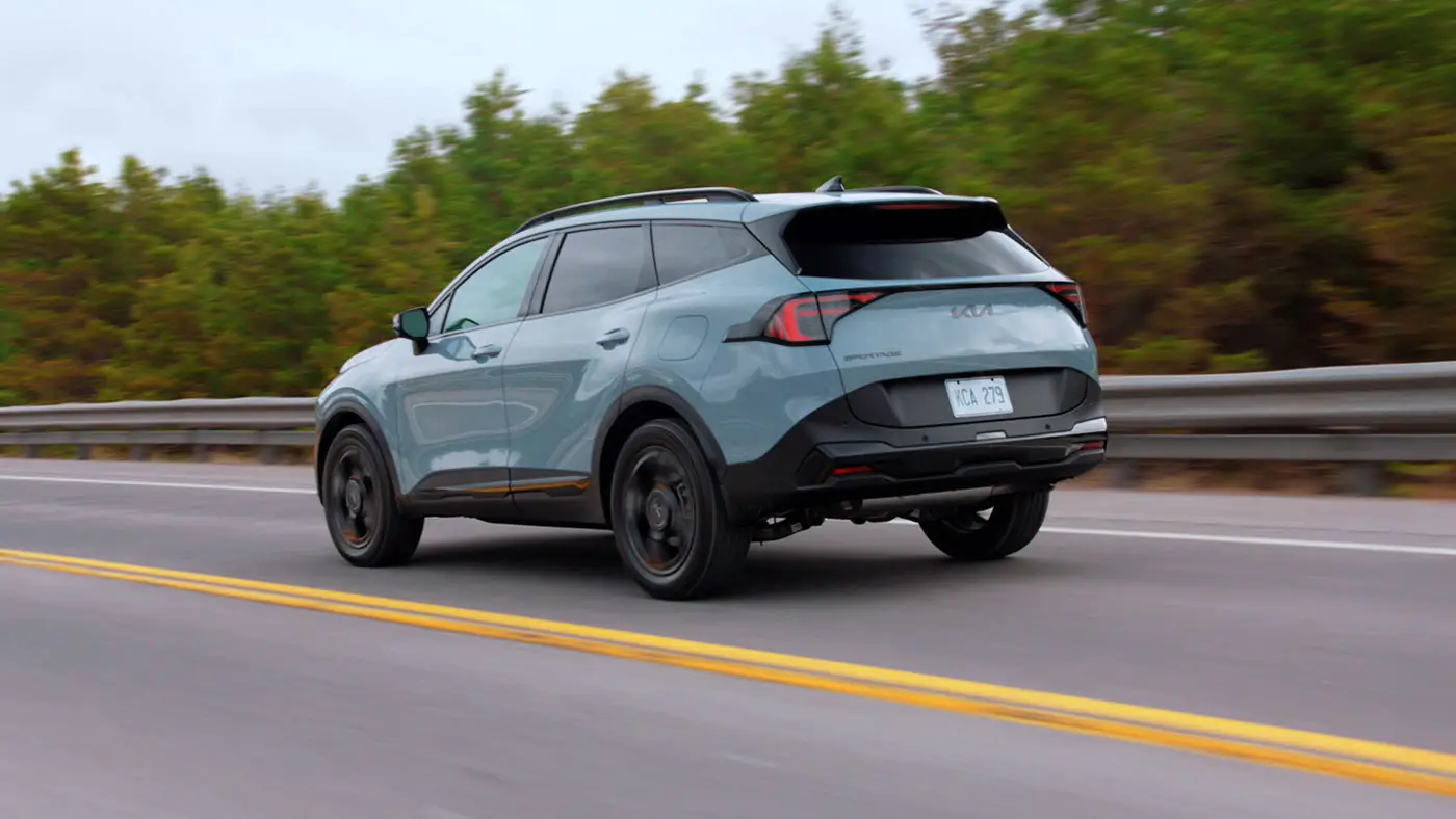 Blue Kia Sportage Compact SUV rear exterior driving
