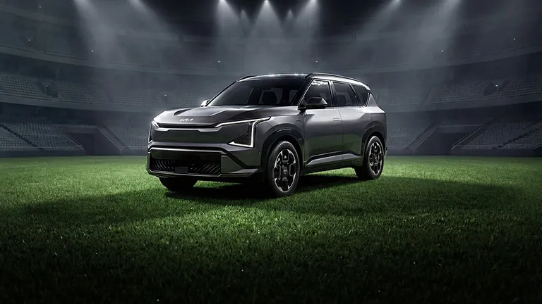 Grey Kia EV5 electric Compact SUV on road rear exterior