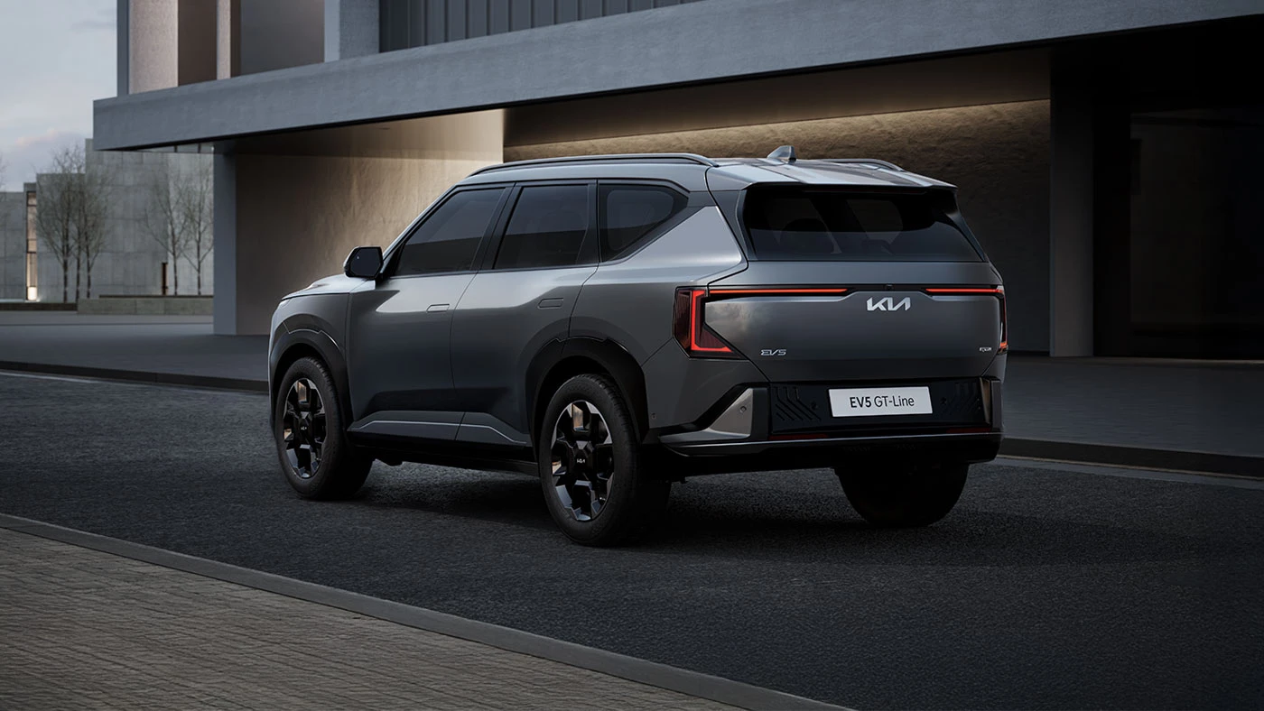 Grey Kia EV5 electric Compact SUV on road rear exterior